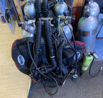 fathom rebreather rigged up as the tech version with faber LP50 tanks, Lola valves, atomic regulators, custom black camo halcyon evolve jj wing with maroon center, spg on left hip with diluent injection through the left hip d-ring